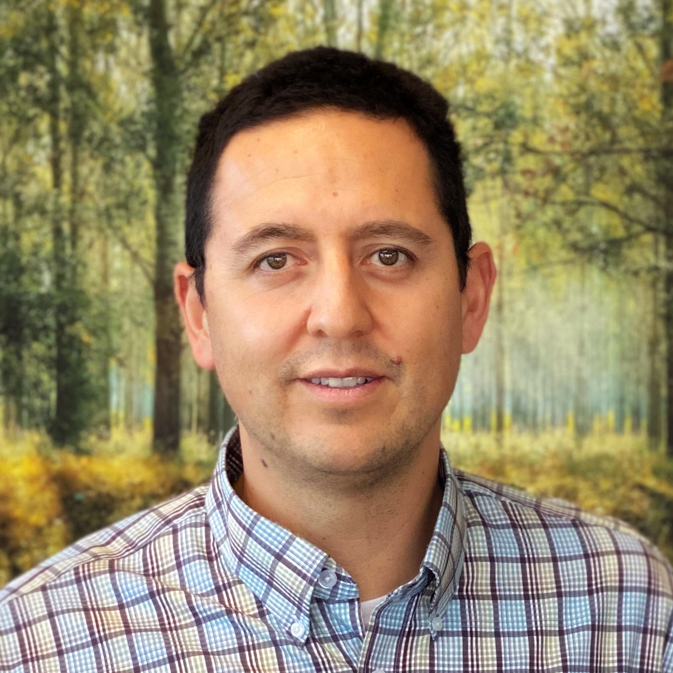 An photograph of Dr. Carlos Canales, a licensed Clinical Psychologist, Certified Group Psychotherapist, and Somatic Experiencing Practitioner in private practice.
